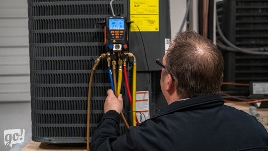 Technician is working on an AC